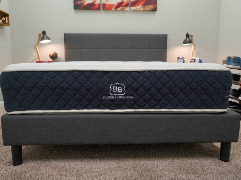 The Brooklyn Bedding Signature mattress on a grey bed frame 
