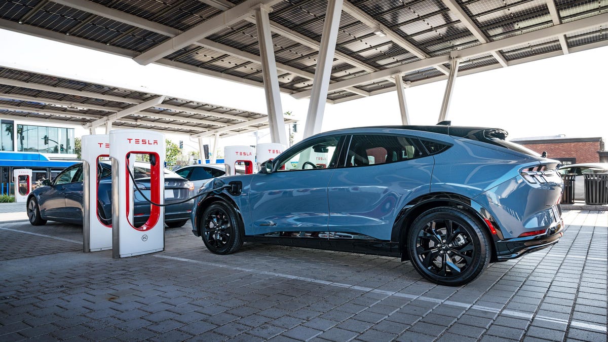 ford mach-e charging at a tesla supercharger station