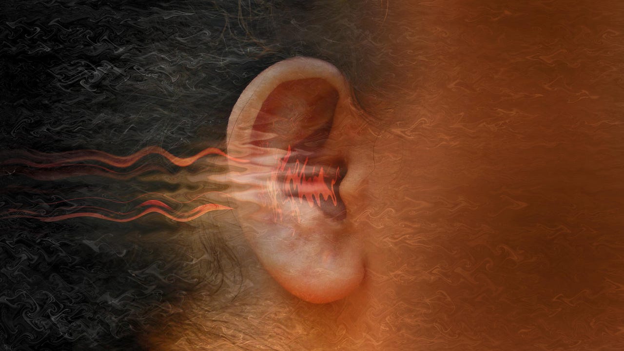 Close-up of a person's ear with red lines flowing into it