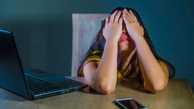 A girl covering her head with her hands in frustration