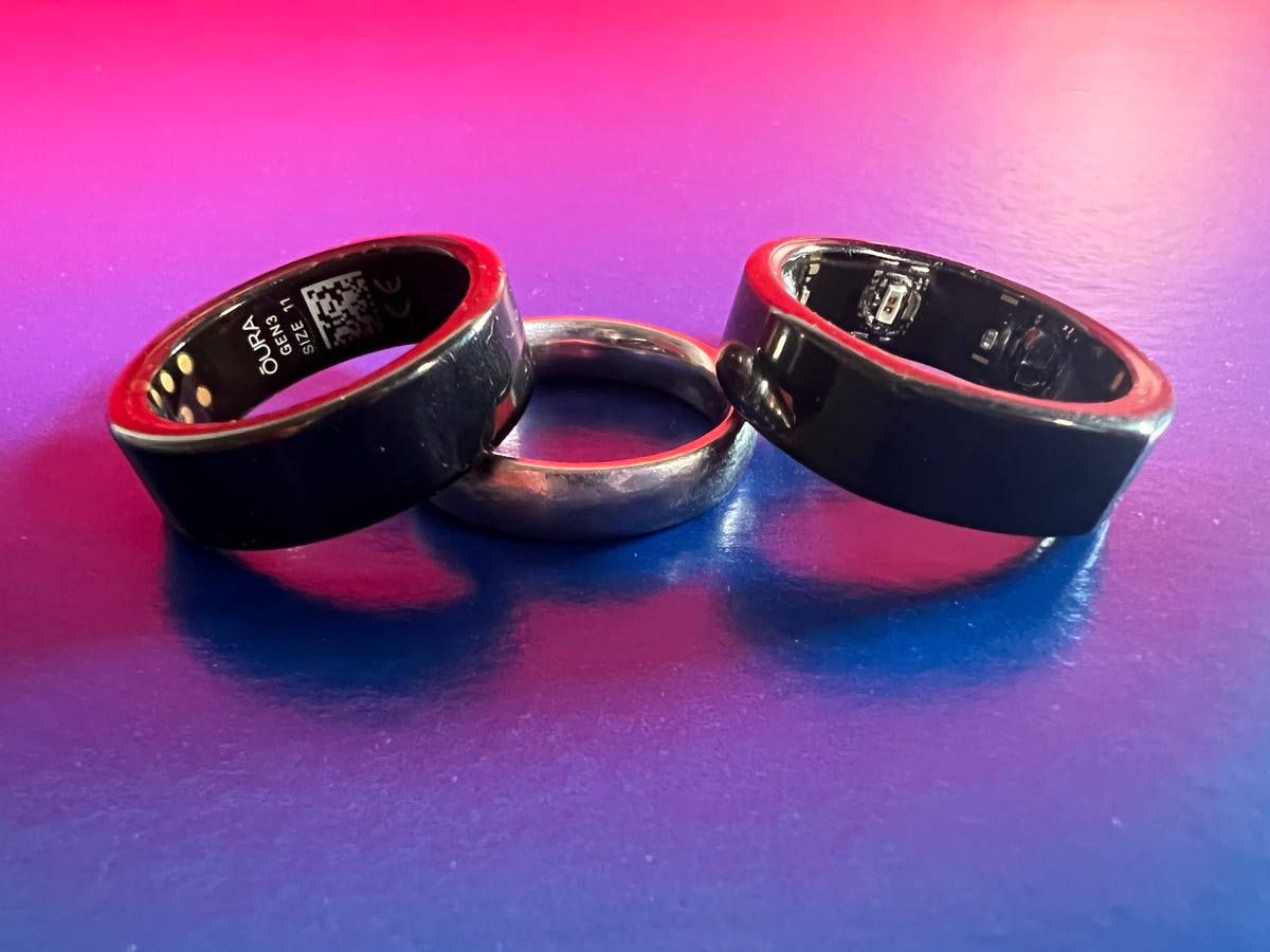 Oura 3 rings next to a wedding ring